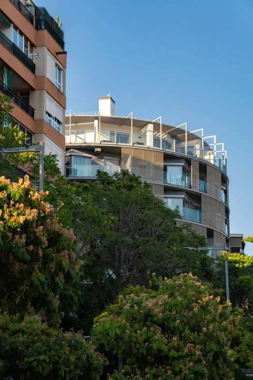 a building with balconies is in the middle of a park