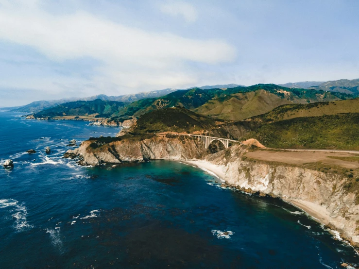 an aerial po of a highway by the ocean