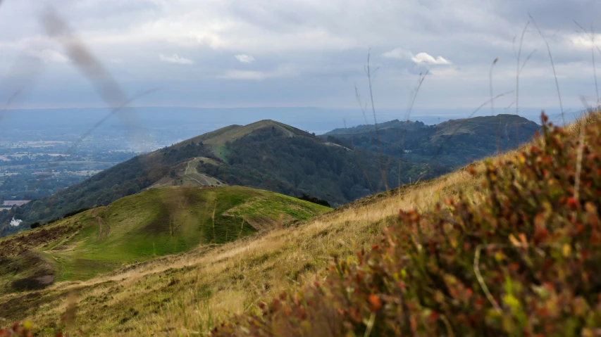 some hills near each other with a view of a town below