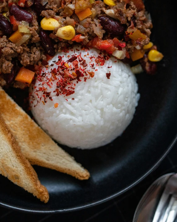 this food entree is topped with rice, beans, and peppers