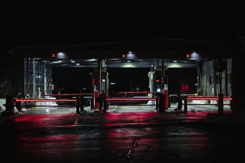 two red seats sitting in the rain underneath a bus stop