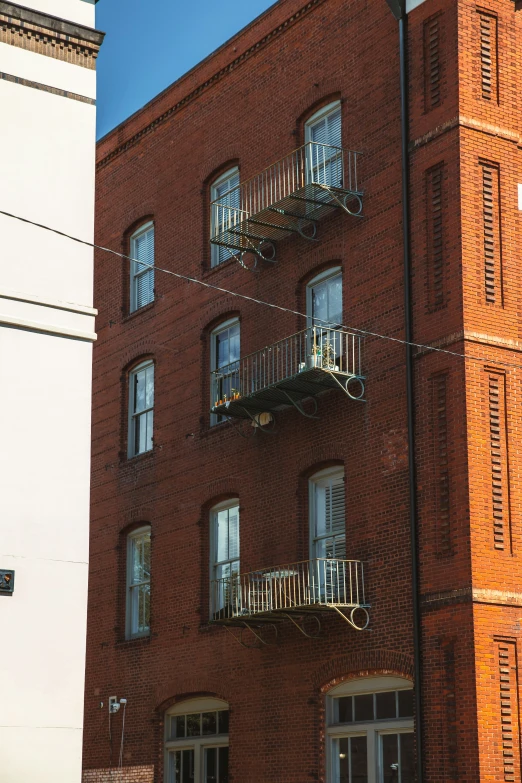 an old brick building is shown with balconies on the second floor