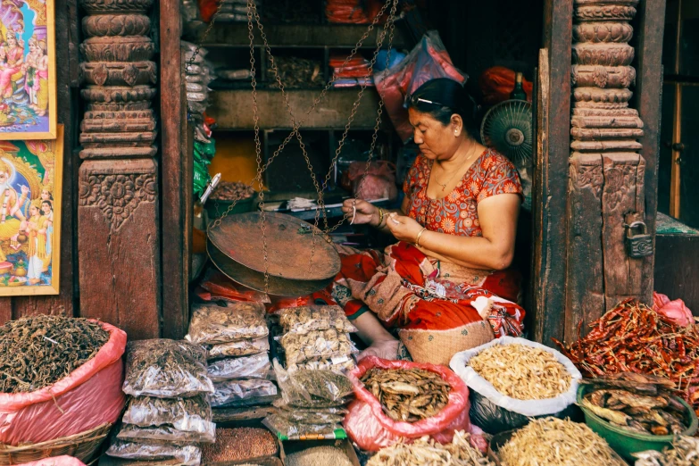 a person in red shirt standing by food and pots