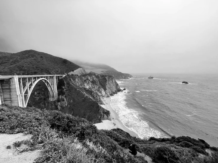 a large bridge sitting next to the ocean