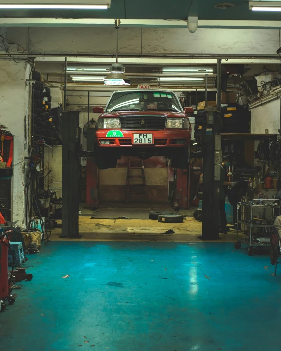 a car sits on top of an overhead lift