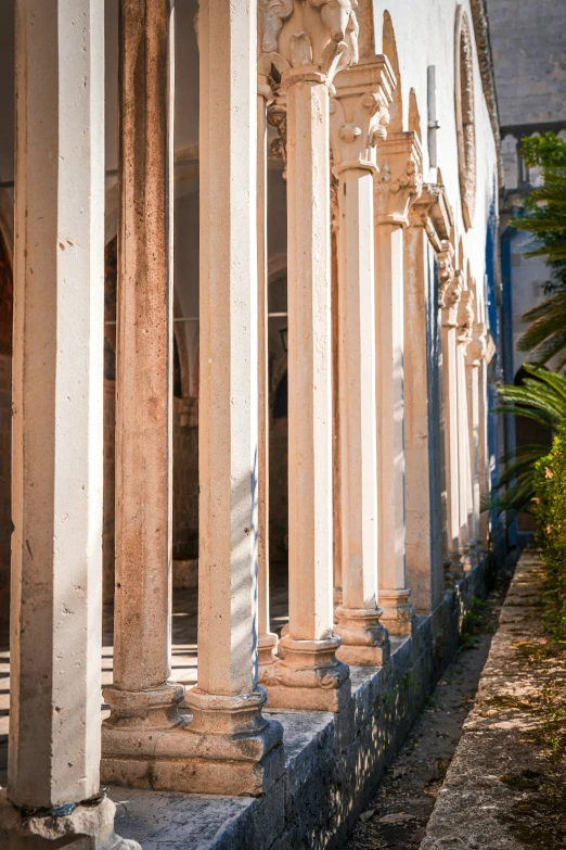 columns lining a stone wall near a building