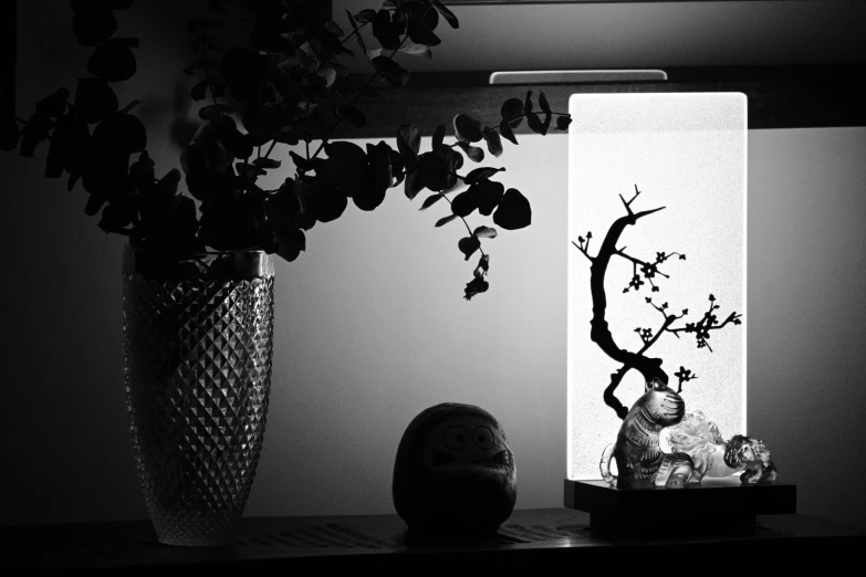 a vase with flowers and rocks on the table