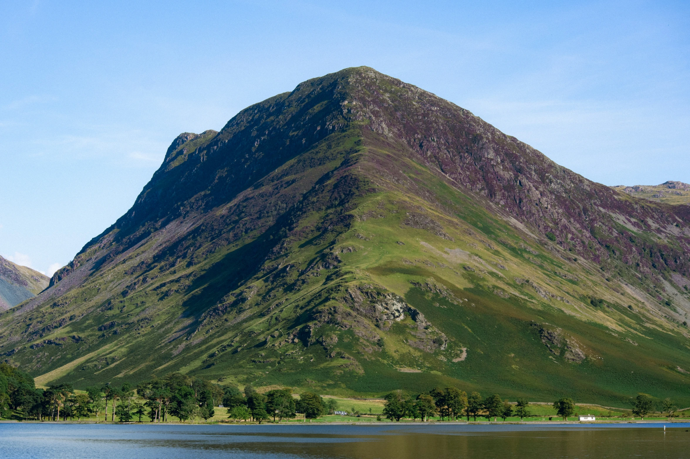 the big mountain is tall and green on top of it