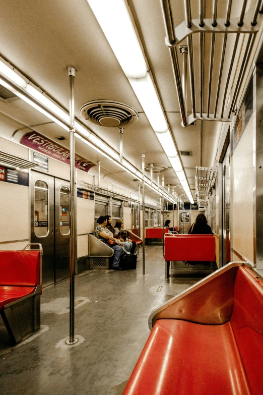 two people resting on the seats in an empty train