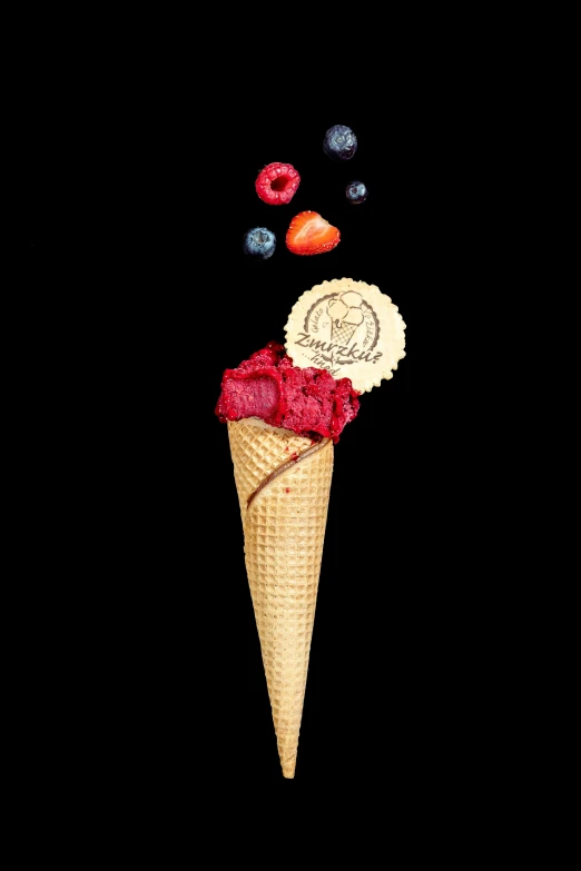 the cone is filled with strawberries, berries and cream