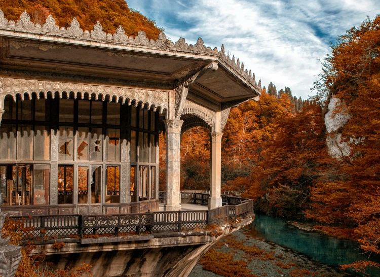 the ornate gazebo at a park overlooks the river