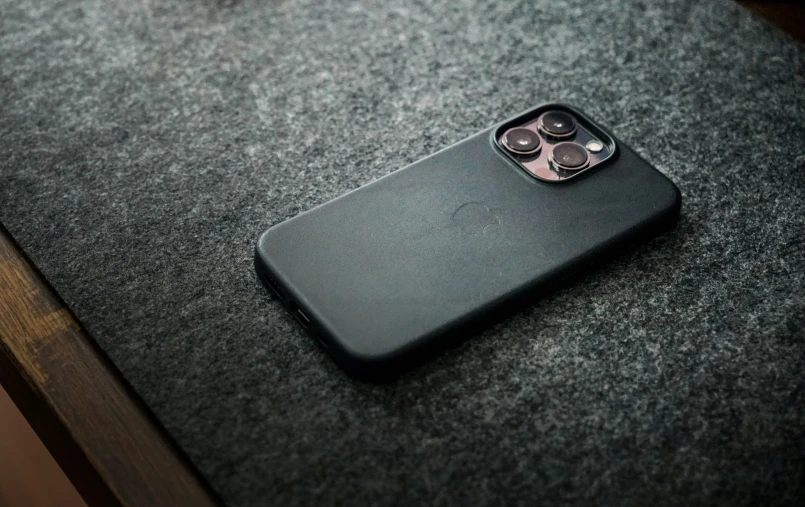 a black phone case sits on a table