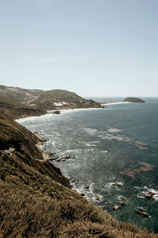 a view of a beach from the top of a hill