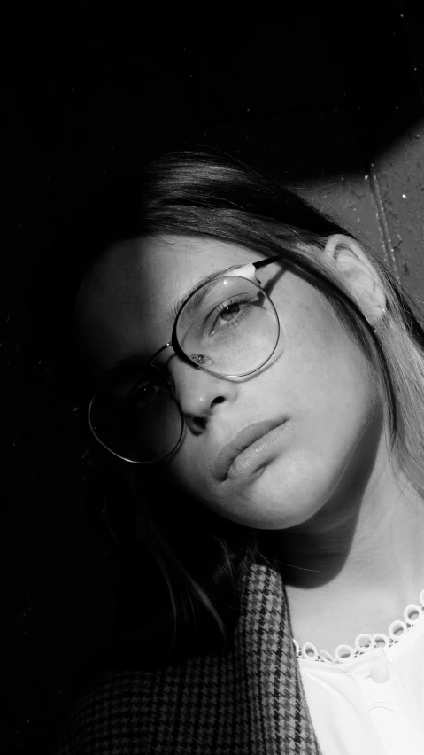 a black and white po of a woman wearing glasses