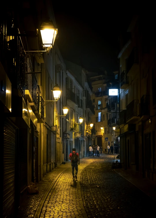 a woman walking down a city street at night