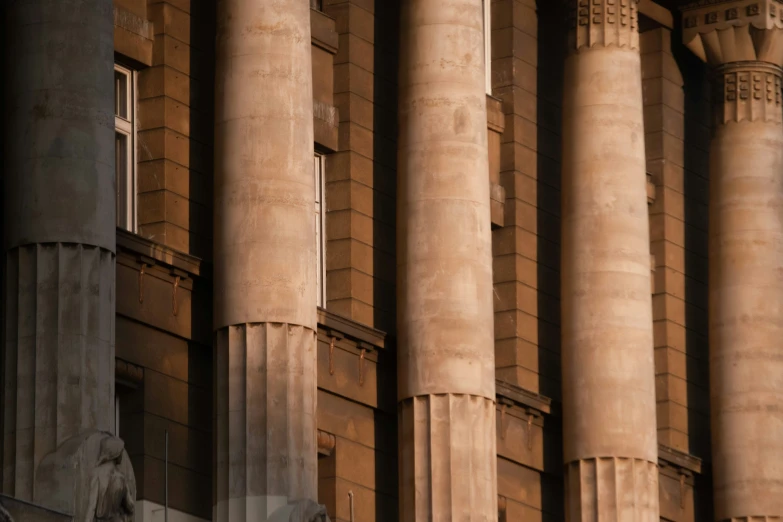 a row of large pillars with clocks on them