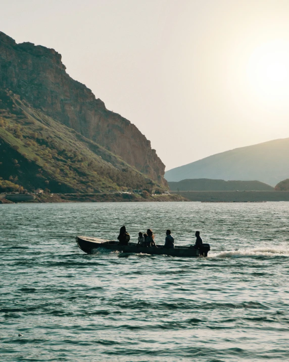 a small boat with people paddling on the water