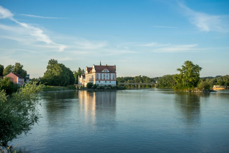 an old building next to a river with a bridge on it