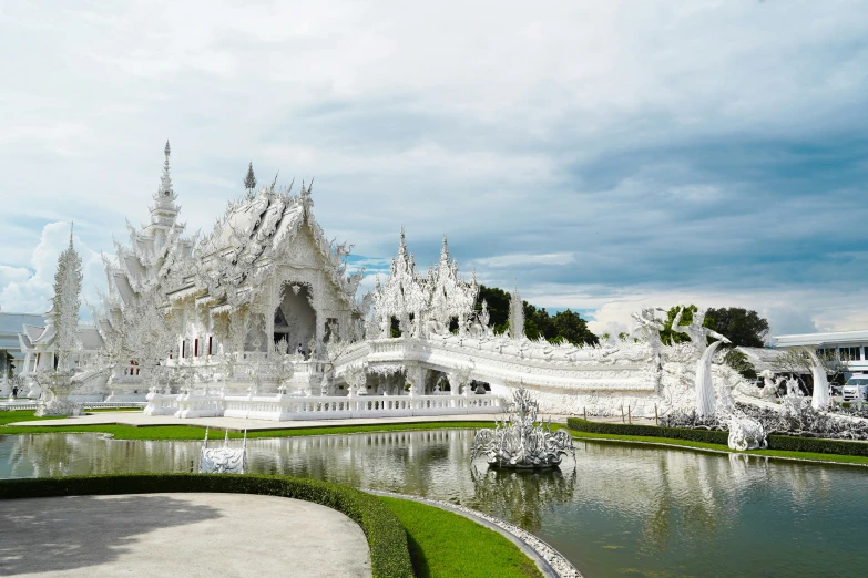 the white pavilion at the park looks like a fantasy castle