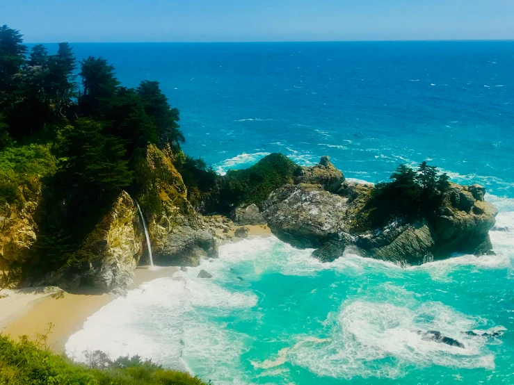 a sandy beach on the coast near the water