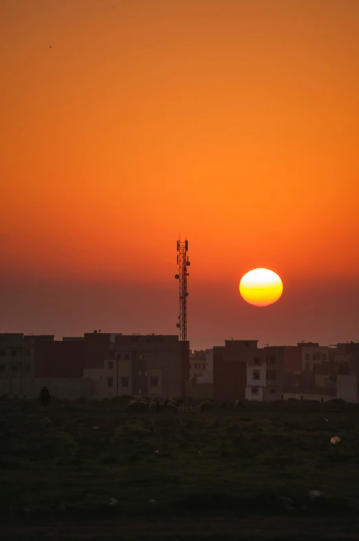 the sun is setting over some houses