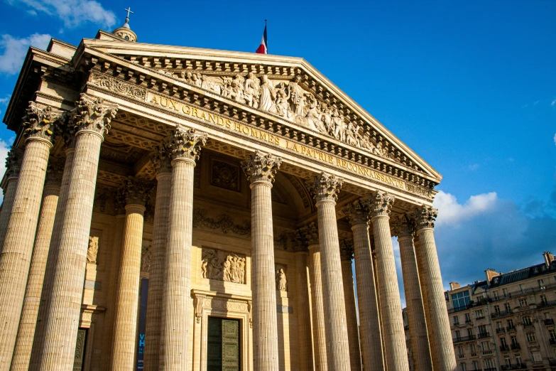 a very tall building with pillars and columns on top