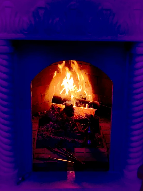 a colorful blue fireplace that has  coal in it