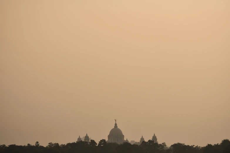 the skyline of a big city is seen in the hazy sky