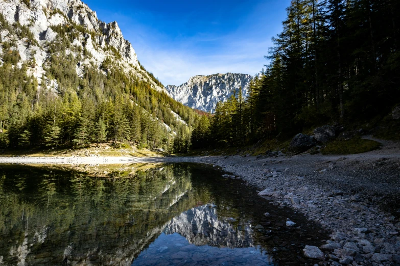 a small lake surrounded by mountains and trees