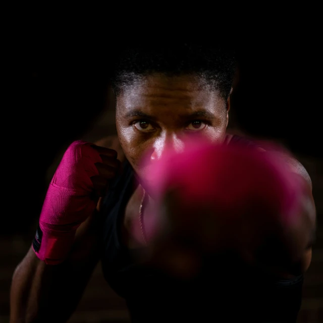 a man holding two red boxing gloves