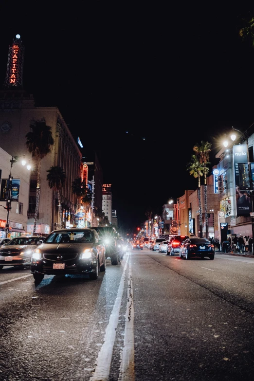 the city is filled with cars and street lights