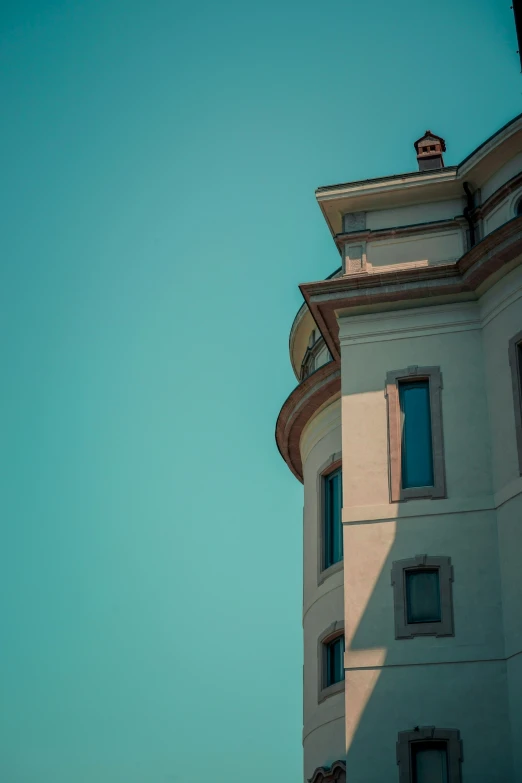 the light blue sky in front of a large building