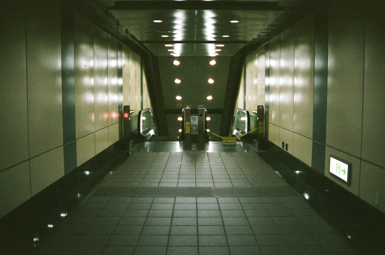 a long narrow hallway leading to some elevators