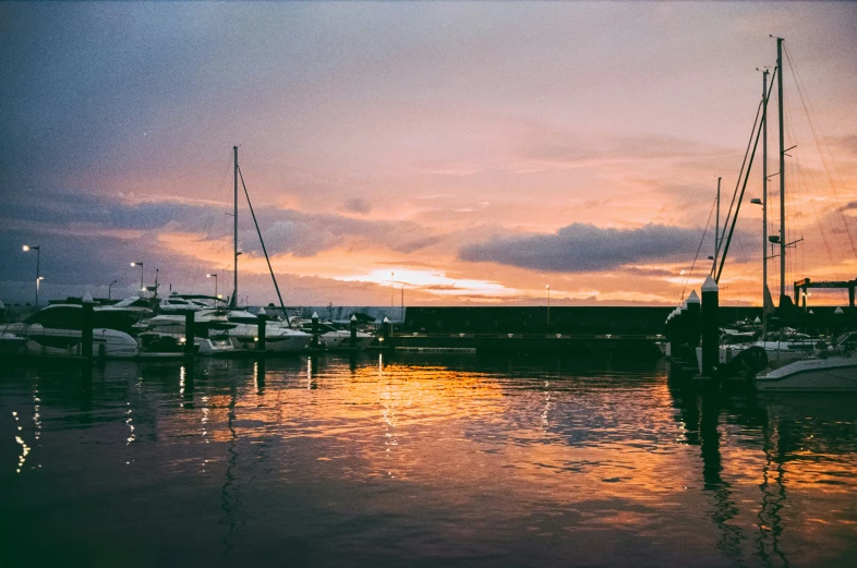 the boats are moored on the water and in the sunset