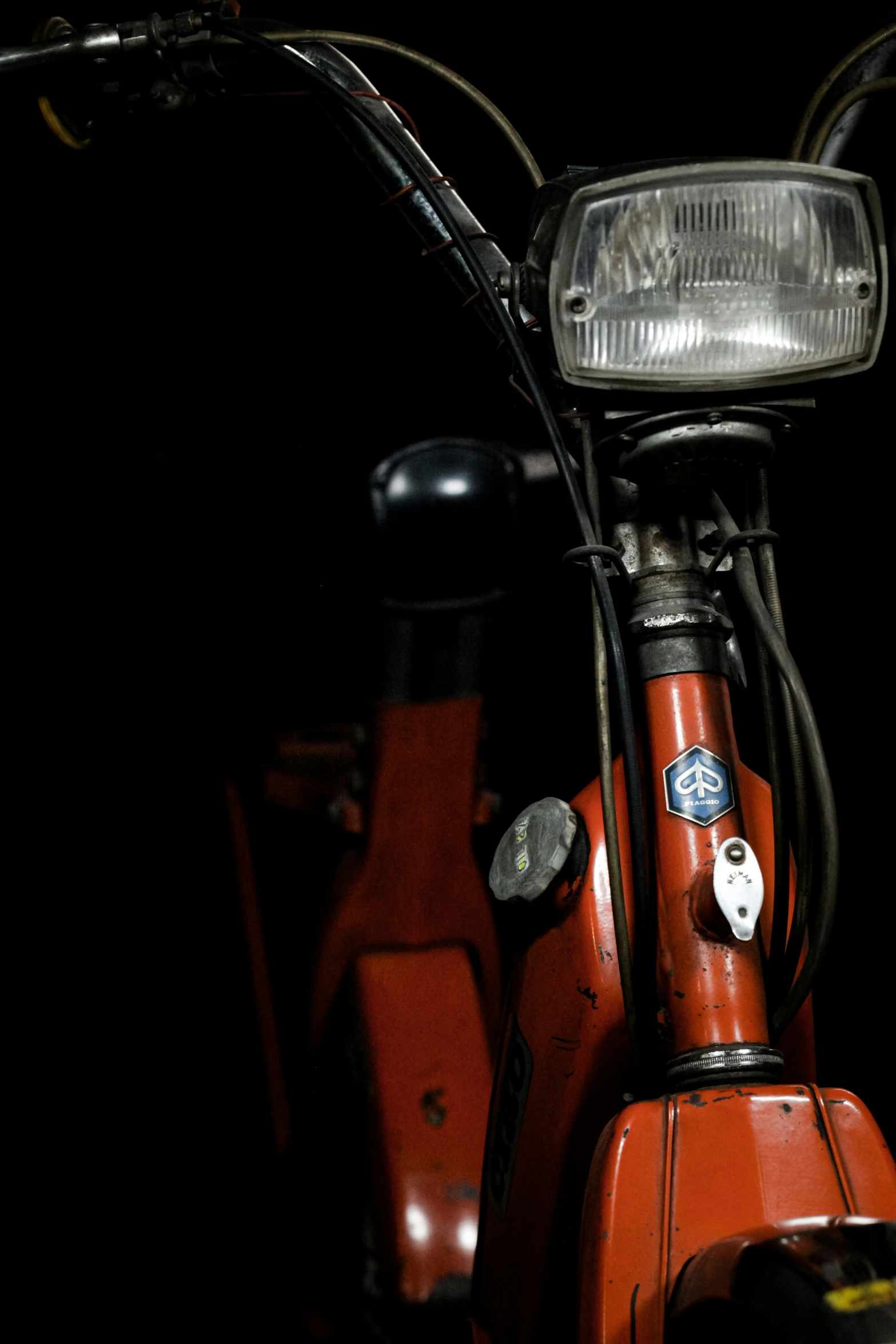 a close up s of the front light on a red motorcycle