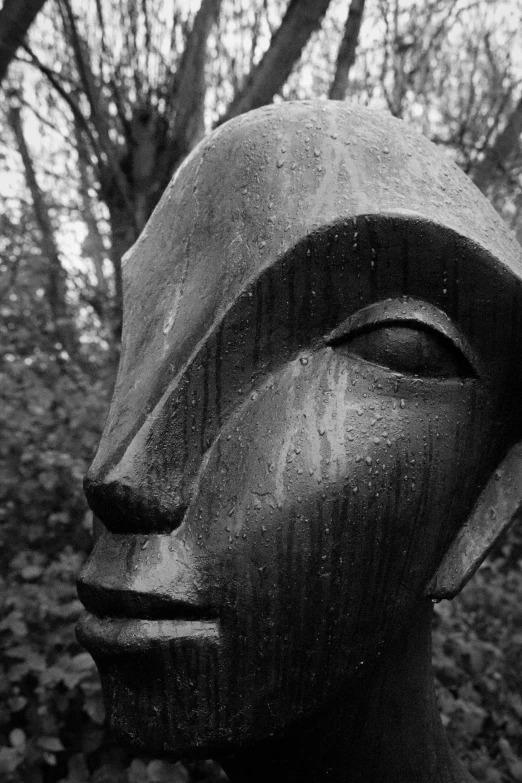 a statue is in the woods with trees