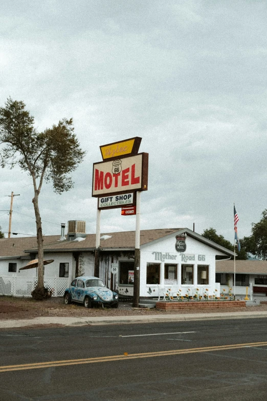 this motel has car parked in front of it