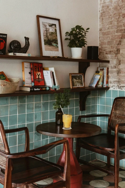 a brick wall with two wooden chairs near one another