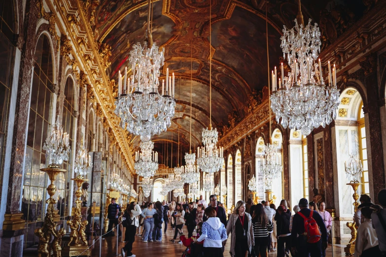 the long hall is filled with beautiful chandeliers