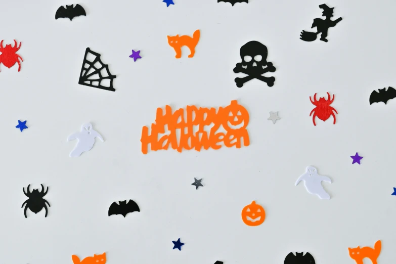 a wall covered in lots of cut out halloween items