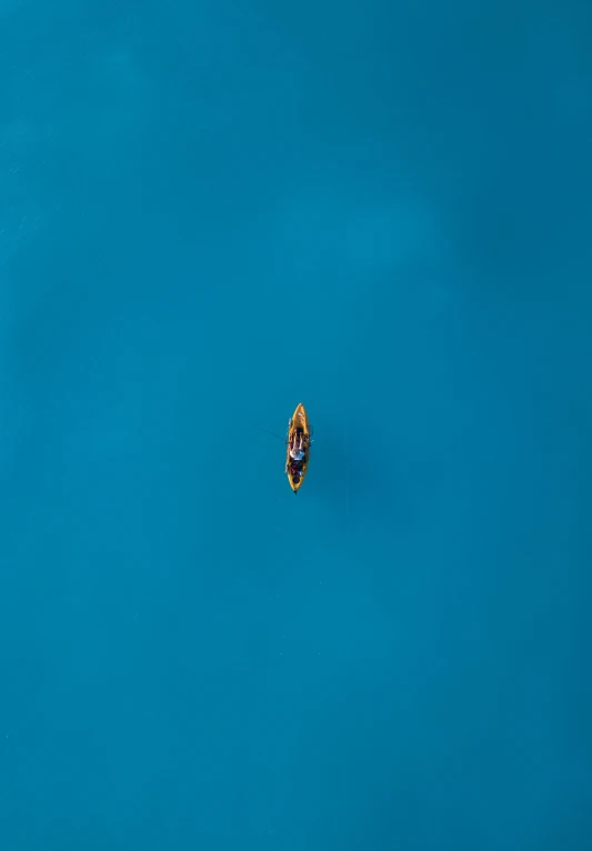 an overhead s of a small boat traveling on water