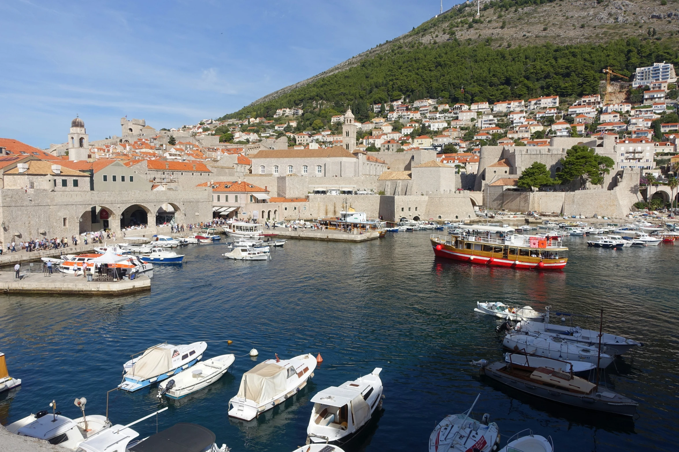 boats docked in harbor of small, old city