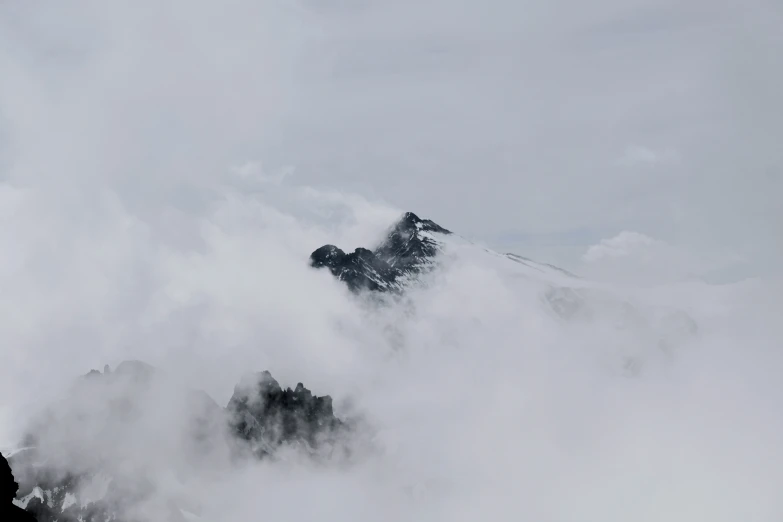 a bunch of clouds that are on the side of a mountain