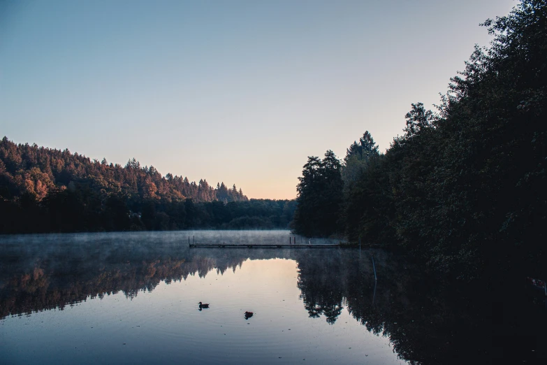 a couple of small boats floating on a lake