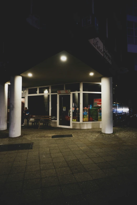 the front of an illuminated building at night