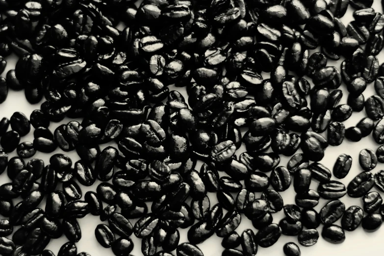 a pile of beans sitting on top of a white table