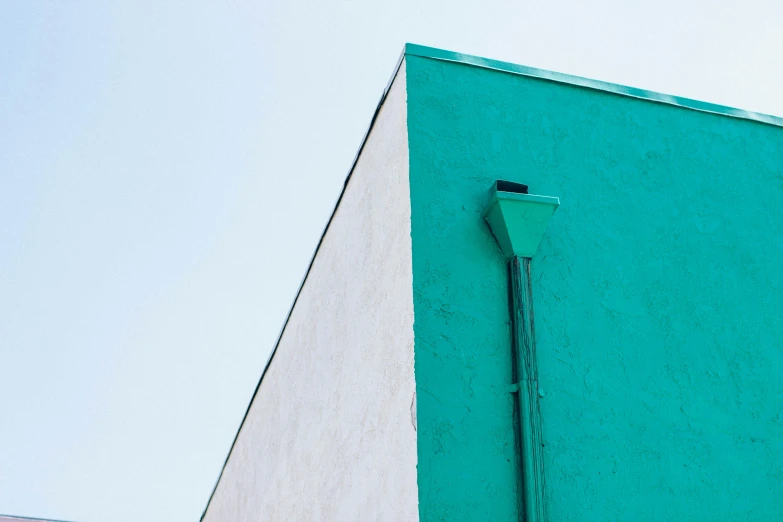 a clock on the side of a building on a corner