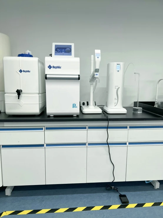 a laboratory table covered in machines and counter top