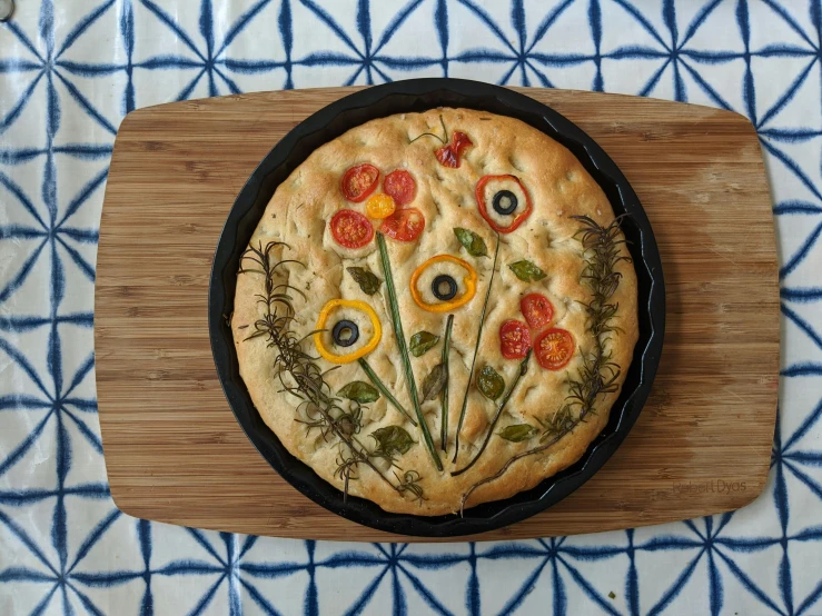 a pizza sitting on top of a wooden  board