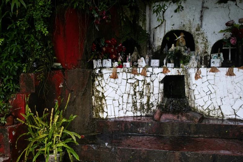 a white gate surrounded by plants and other decoration